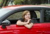 attractive-woman-smiling-proud-sitting-driver-seat-holding-showing-car-key-new-automobile-buyi...jpg