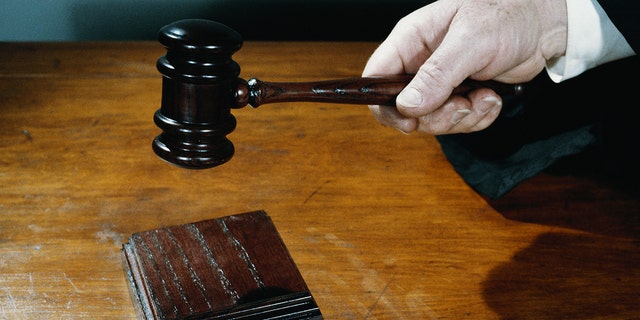 Close-up of judge holding gavel