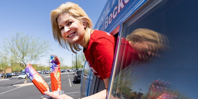 Republican candidate for U.S. Congress April Becker poses in the window of her campaign van, a converted ice cream truck, in Las Vegas on Sunday, May 29, 2022.