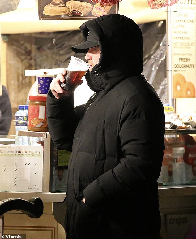 Wayne put on a very low-key display in a black padded coat with the hood pulled up to cover his face